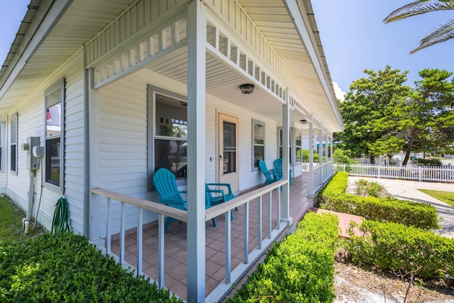 view of side of property featuring covered porch