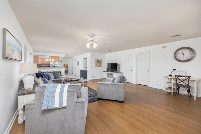 living room featuring hardwood / wood-style flooring and ceiling fan