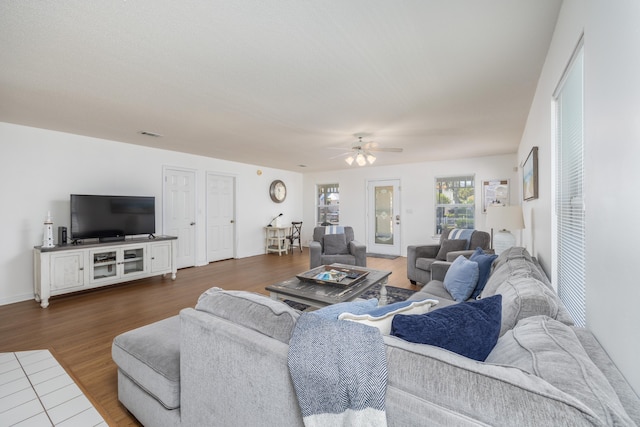 living room with ceiling fan and dark hardwood / wood-style flooring