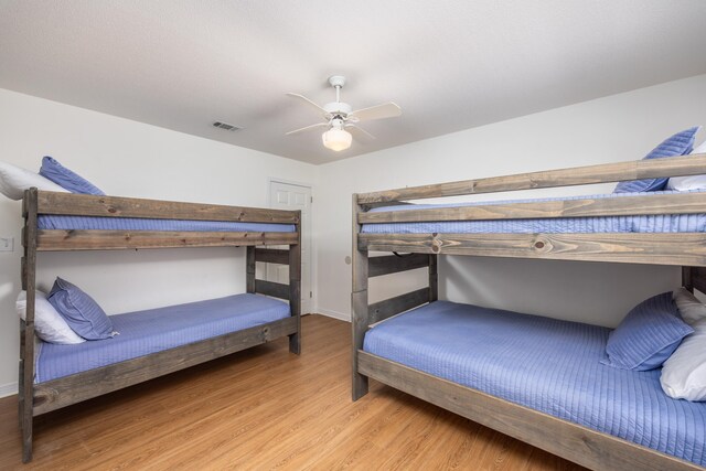 bedroom with light wood-type flooring and ceiling fan