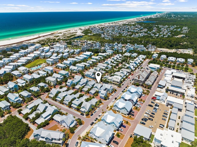 drone / aerial view featuring a water view and a view of the beach