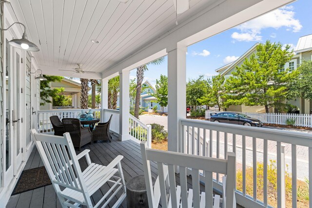 wooden deck featuring ceiling fan and a porch