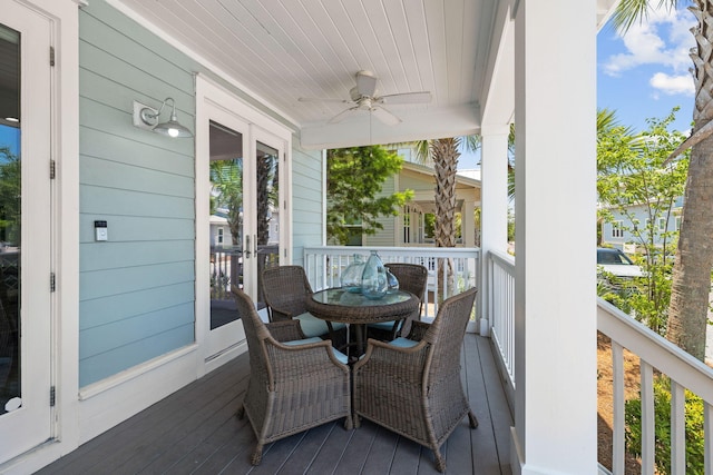 deck with ceiling fan and covered porch