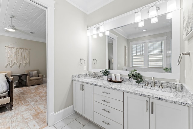 bathroom with crown molding, vanity, and ceiling fan