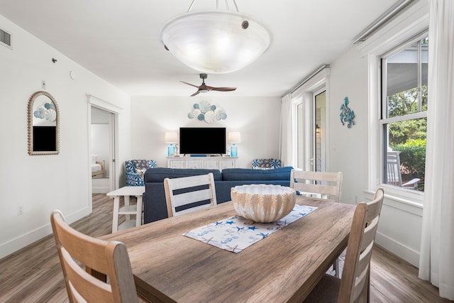 dining space with ceiling fan and hardwood / wood-style flooring