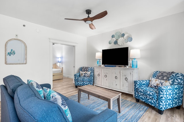 living room with ceiling fan and light hardwood / wood-style floors