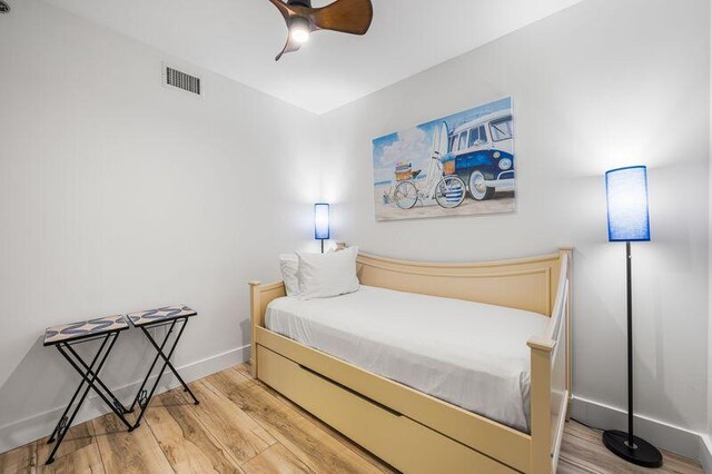 bedroom with hardwood / wood-style flooring and ceiling fan