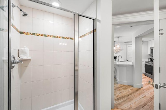 bathroom featuring sink, wood-type flooring, and walk in shower