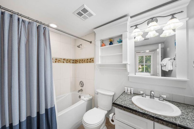 full bathroom featuring vanity, toilet, and shower / tub combo with curtain