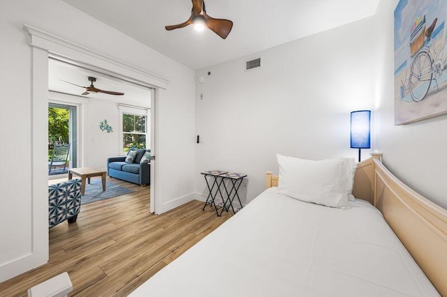 bedroom with ceiling fan and light hardwood / wood-style flooring