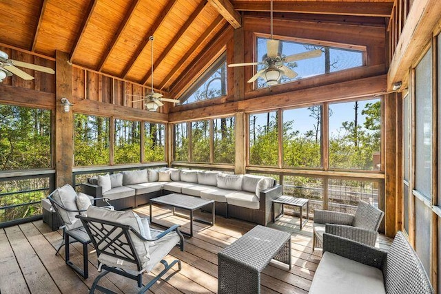 sunroom / solarium with a wealth of natural light, ceiling fan, and lofted ceiling with beams