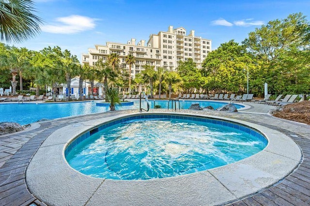 view of swimming pool featuring a community hot tub