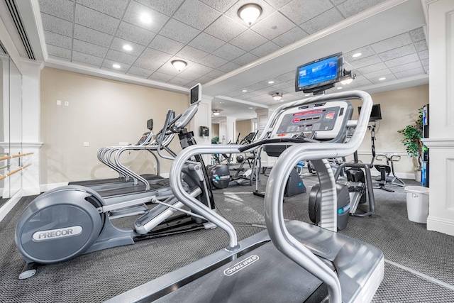 workout area featuring a drop ceiling and ornamental molding