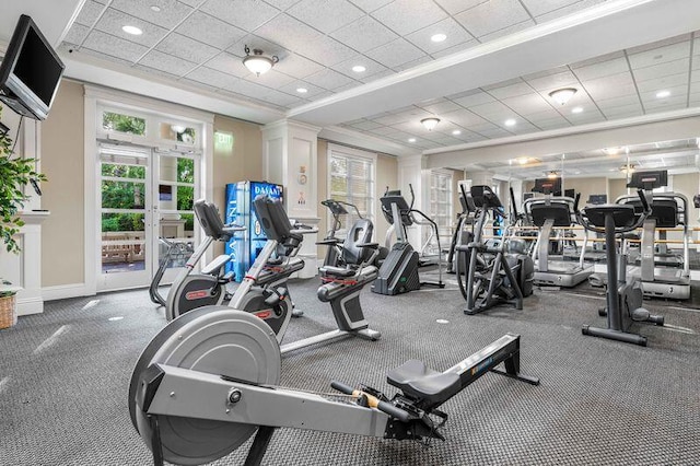 workout area with a paneled ceiling and a wealth of natural light