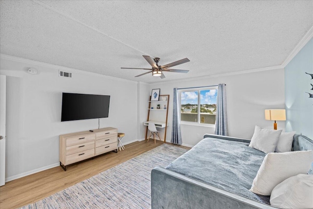 bedroom with crown molding, ceiling fan, hardwood / wood-style floors, and a textured ceiling
