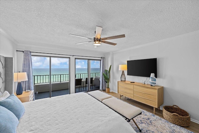 bedroom with hardwood / wood-style flooring, ornamental molding, access to outside, ceiling fan, and a textured ceiling