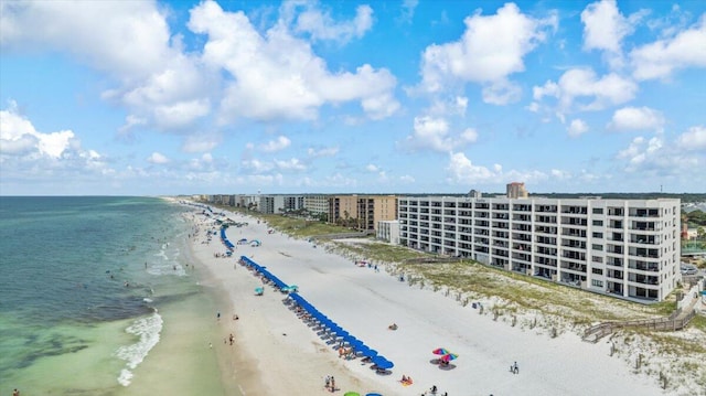 drone / aerial view featuring a water view and a view of the beach