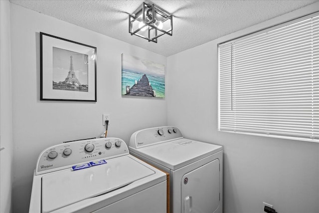 laundry room featuring washer and dryer and a textured ceiling