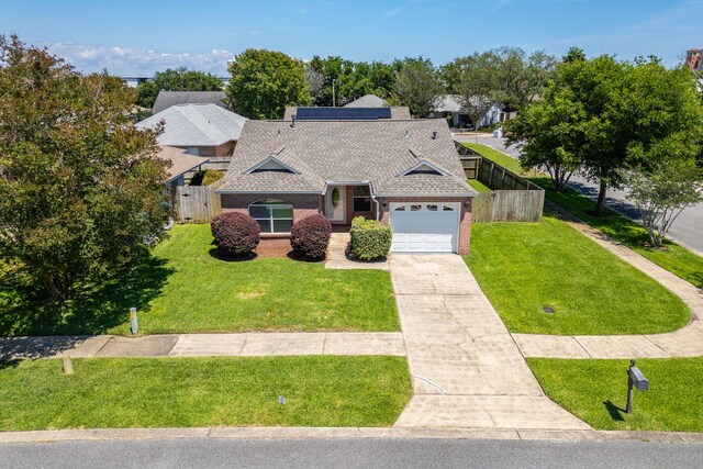 view of front of home with a garage and a front lawn