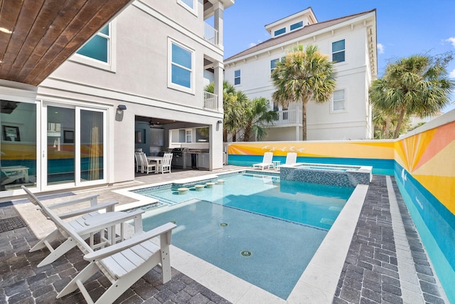 view of swimming pool with an in ground hot tub and a patio area