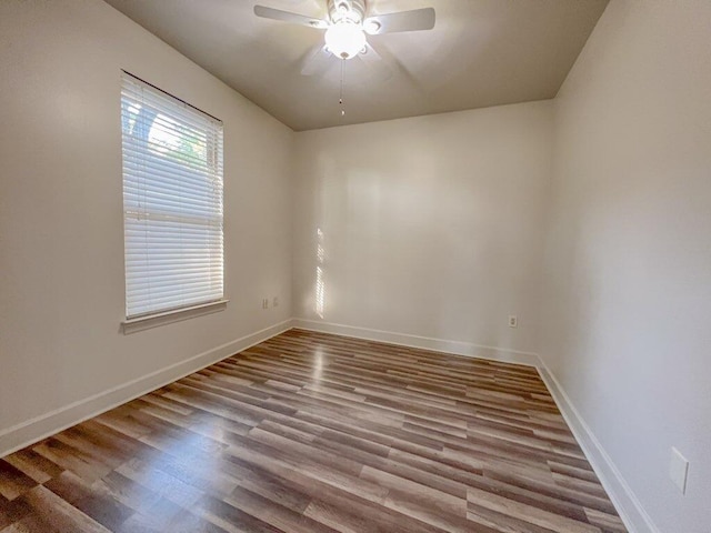 spare room with ceiling fan and light wood-type flooring