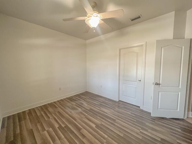 unfurnished bedroom featuring ceiling fan and dark wood-type flooring