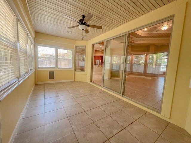 unfurnished sunroom with ceiling fan and wooden ceiling