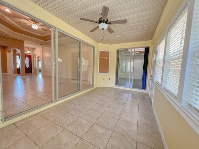 unfurnished sunroom with a tray ceiling and wood ceiling