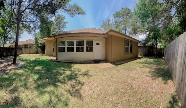 back of house featuring a yard