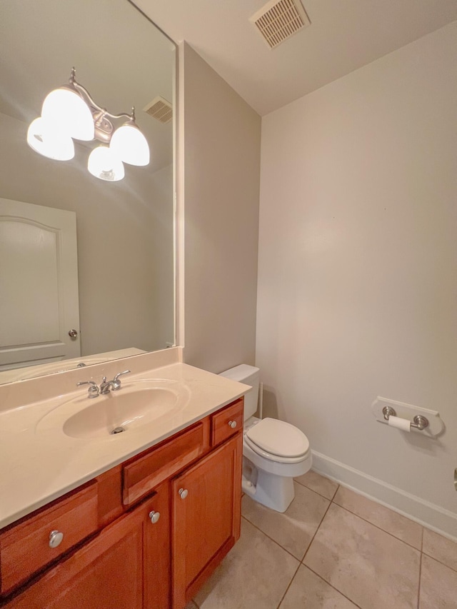 bathroom with tile patterned floors, vanity, and toilet