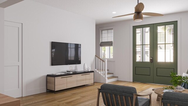 living room featuring ceiling fan, hardwood / wood-style flooring, and french doors