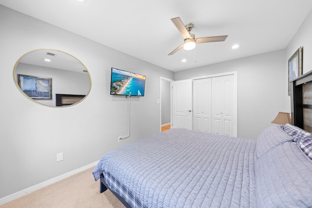 bedroom with a closet, carpet floors, and ceiling fan