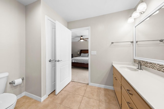 bathroom featuring tile floors, ceiling fan, toilet, and vanity