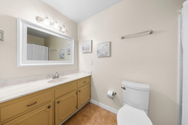 bathroom featuring vanity, toilet, and tile floors