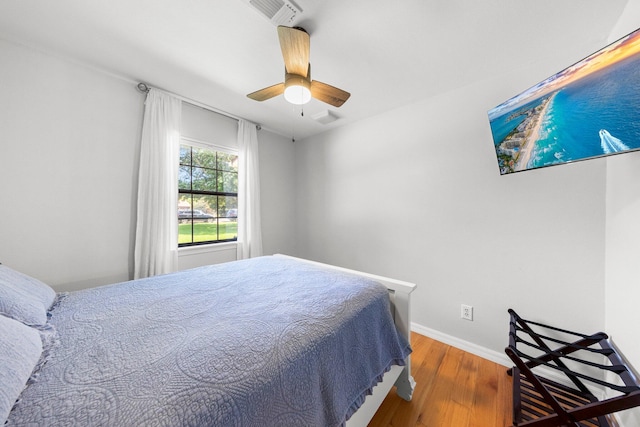 bedroom with ceiling fan and hardwood / wood-style floors