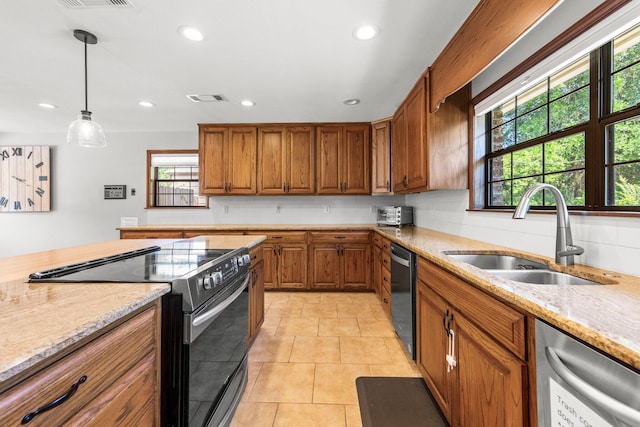 kitchen with light stone countertops, electric range, decorative light fixtures, sink, and light tile floors