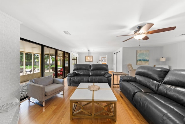 living room featuring light wood-type flooring and ceiling fan