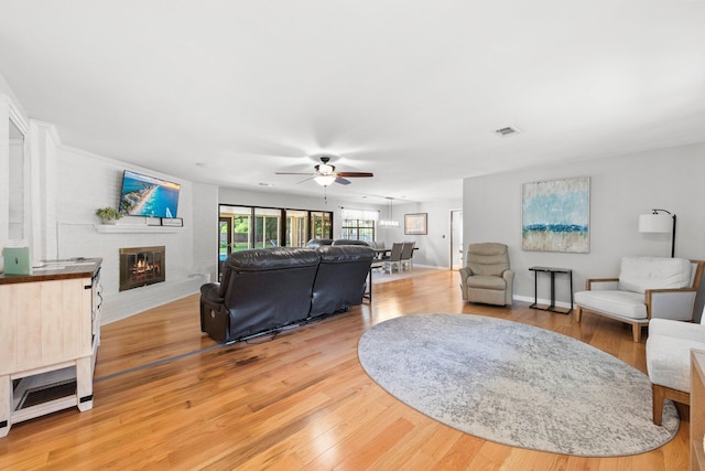 living room featuring light wood-type flooring and ceiling fan