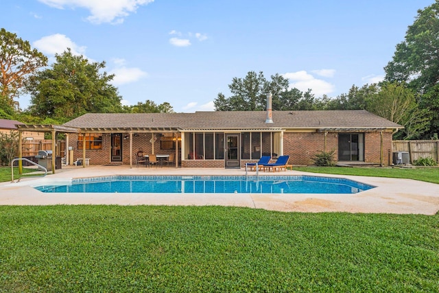 view of swimming pool with a yard, central AC unit, and a patio area