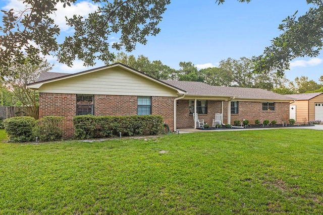 single story home with a garage and a front lawn