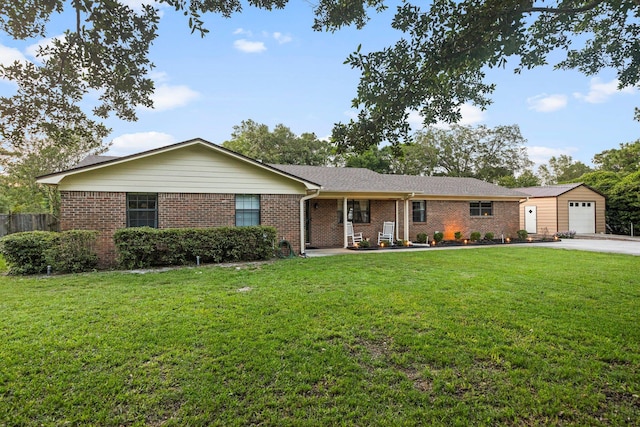 ranch-style house featuring an outdoor structure and a front lawn