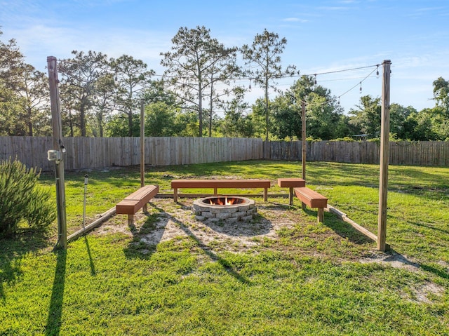 view of yard with a fire pit