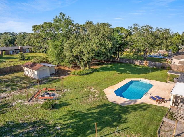 view of swimming pool with a patio area, a yard, and an outdoor structure