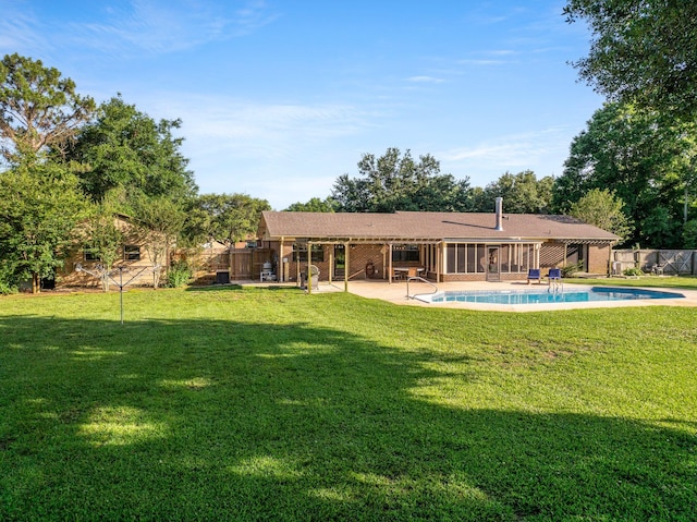 back of house with a yard, a fenced in pool, and a patio