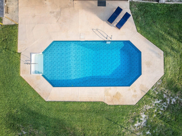 view of pool with a yard