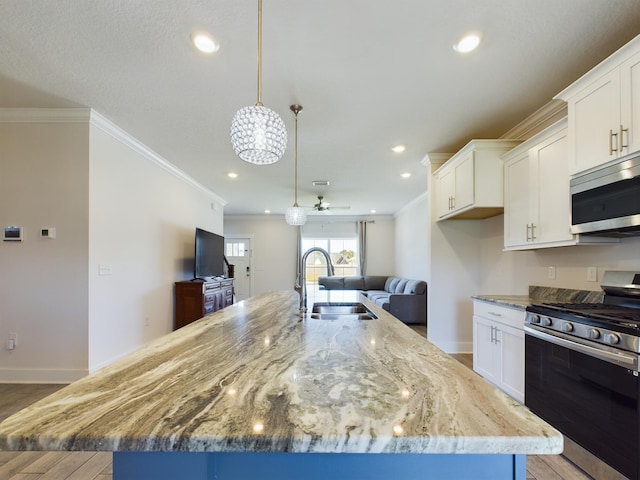 kitchen with stainless steel appliances, a kitchen island with sink, light stone counters, and decorative light fixtures