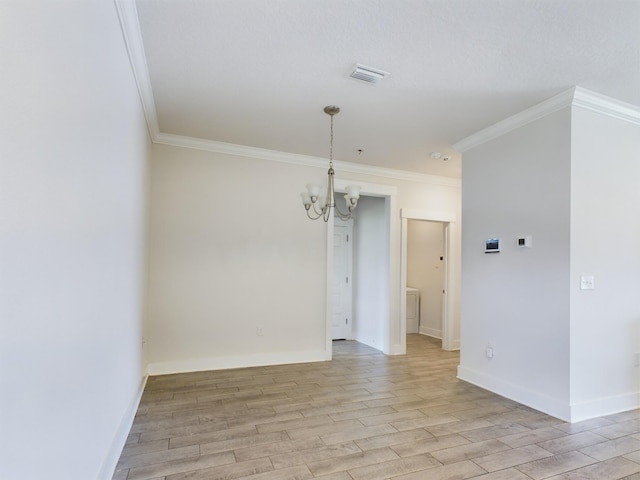 empty room featuring crown molding, light hardwood / wood-style flooring, and a chandelier