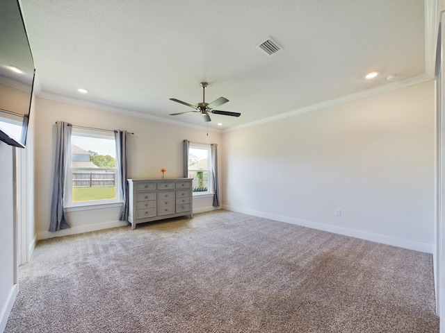 unfurnished bedroom featuring crown molding, light colored carpet, and ceiling fan