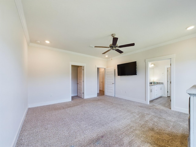 unfurnished bedroom with ceiling fan, ensuite bath, ornamental molding, and light carpet