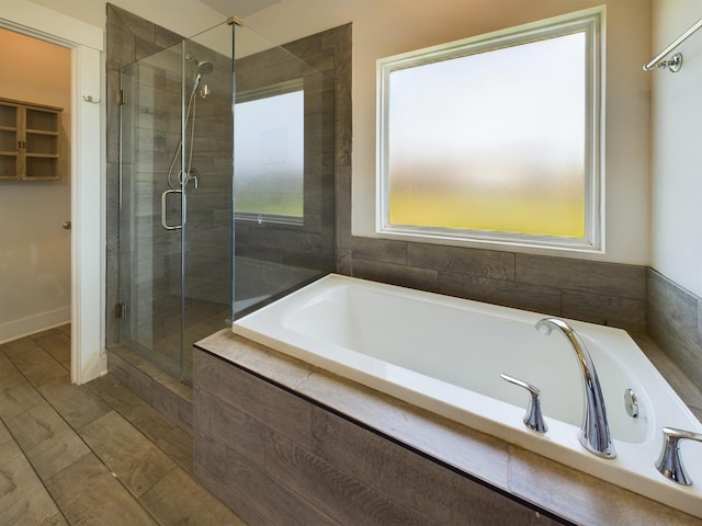 bathroom featuring separate shower and tub